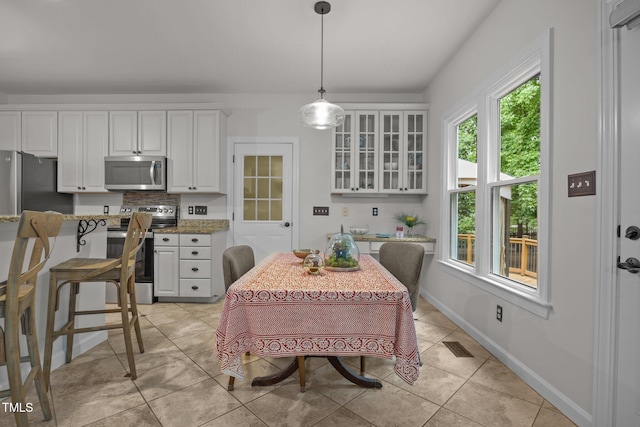 106 Fawley Ct, Cary, NC 27519 - dining space featuring light tile patterned floors and baseboards