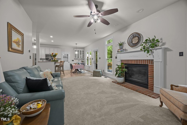 106 Fawley Ct, Cary, NC 27519 - carpeted living room with a brick fireplace, ceiling fan, and recessed lighting