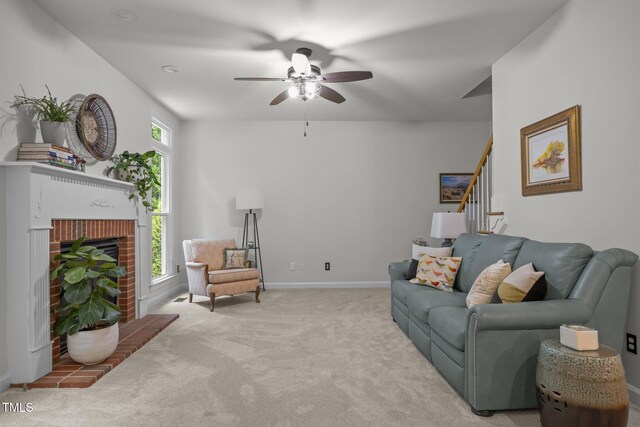 106 Fawley Ct, Cary, NC 27519 - carpeted living area featuring stairs, ceiling fan, a brick fireplace, and baseboards