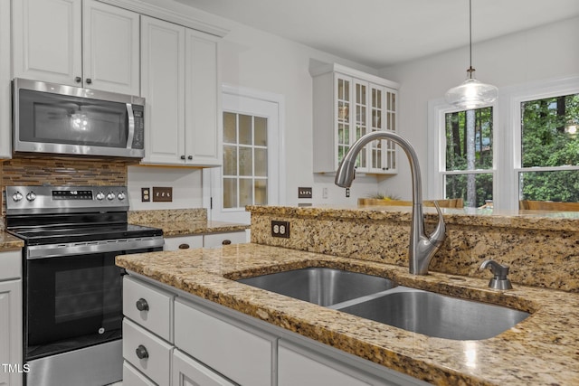 106 Fawley Ct, Cary, NC 27519 - kitchen with appliances with stainless steel finishes, a sink, light stone countertops, white cabinetry, and tasteful backsplash