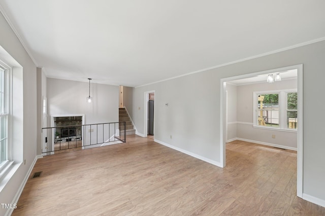 1308 Swallow Dr, Raleigh, NC 27606 - spare room featuring light wood-type flooring, baseboards, ornamental molding, a chandelier, and stairs