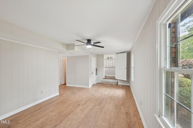 1308 Swallow Dr, Raleigh, NC 27606 - unfurnished living room with light wood finished floors, ceiling fan, and baseboards