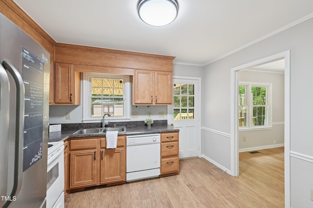1308 Swallow Dr, Raleigh, NC 27606 - kitchen with white appliances, a sink, light wood-style floors, crown molding, and dark countertops