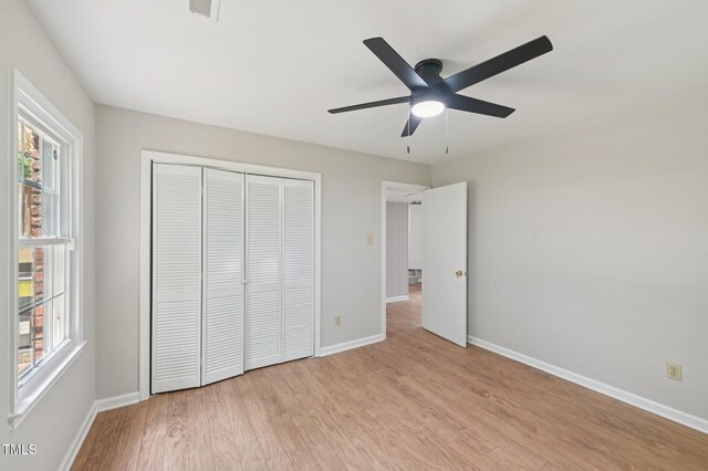 1308 Swallow Dr, Raleigh, NC 27606 - unfurnished bedroom featuring baseboards, light wood-type flooring, a closet, and a ceiling fan