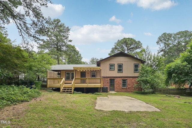 1308 Swallow Dr, Raleigh, NC 27606 - rear view of property featuring a patio, a deck, brick siding, and central AC