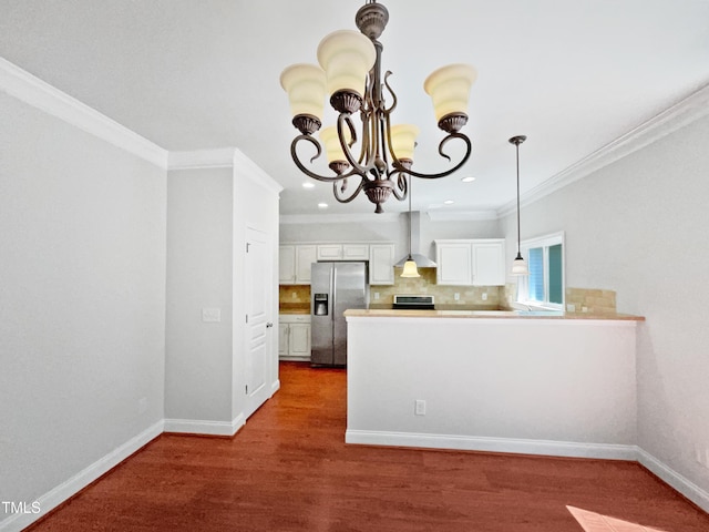 148 Daneborg Rd, Durham, NC 27703 - kitchen with appliances with stainless steel finishes, wall chimney exhaust hood, a chandelier, ornamental molding, and white cabinetry