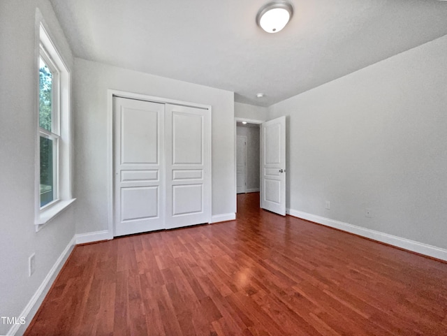148 Daneborg Rd, Durham, NC 27703 - unfurnished bedroom featuring wood finished floors, baseboards, and a closet