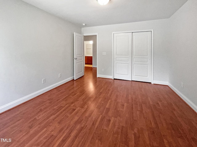 148 Daneborg Rd, Durham, NC 27703 - unfurnished bedroom featuring wood finished floors, baseboards, and a closet