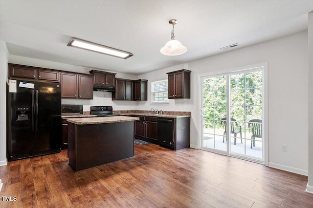 228 Botanical Ct, Bunnlevel, NC 28323 - kitchen featuring black appliances, dark brown cabinetry, under cabinet range hood, a sink, and dark wood-type flooring