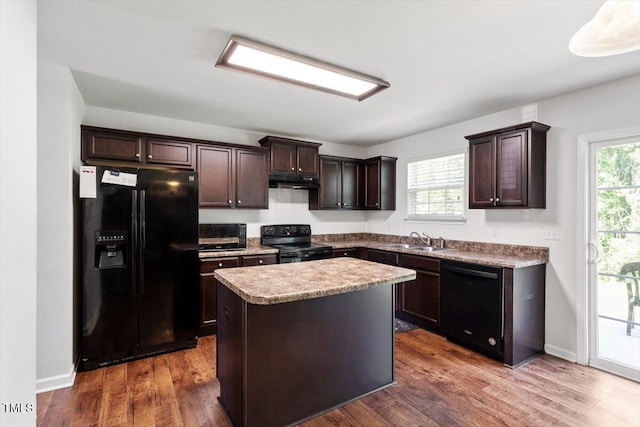 228 Botanical Ct, Bunnlevel, NC 28323 - kitchen featuring black appliances, under cabinet range hood, a sink, and dark brown cabinetry