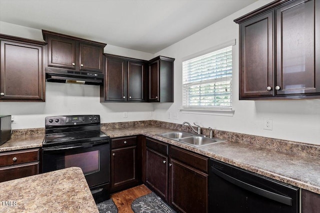 228 Botanical Ct, Bunnlevel, NC 28323 - kitchen featuring under cabinet range hood, black appliances, a sink, dark brown cabinetry, and dark wood-style floors