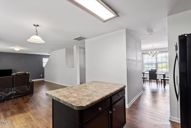 228 Botanical Ct, Bunnlevel, NC 28323 - kitchen with freestanding refrigerator, a chandelier, dark wood-style flooring, hanging light fixtures, and baseboards