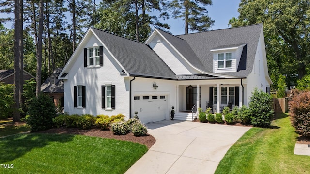 911 Canterbury Rd, Raleigh, NC 27607 - view of front of property featuring covered porch, an attached garage, driveway, brick siding, and roof with shingles
