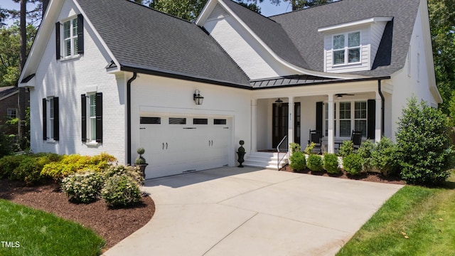 911 Canterbury Rd, Raleigh, NC 27607 - modern farmhouse style home with covered porch, brick siding, a garage, concrete driveway, and a shingled roof
