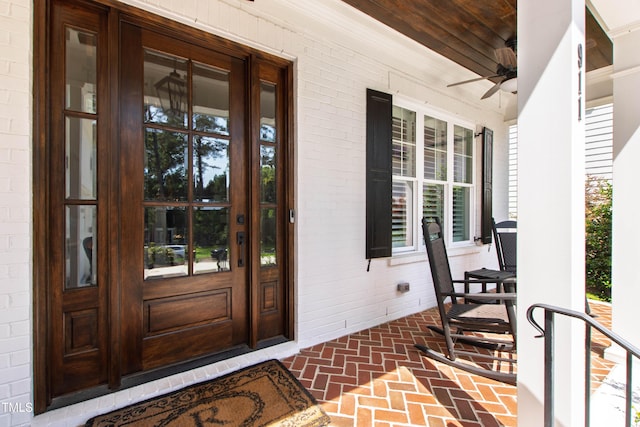 911 Canterbury Rd, Raleigh, NC 27607 - property entrance featuring covered porch, a ceiling fan, and brick siding