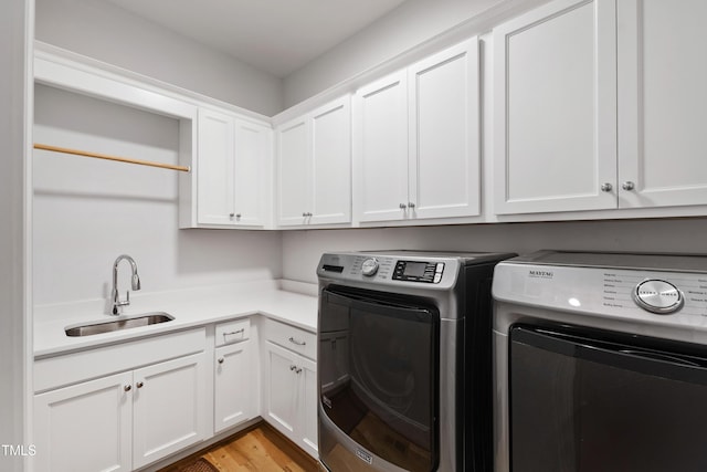 911 Canterbury Rd, Raleigh, NC 27607 - laundry room with separate washer and dryer, cabinet space, and light wood-type flooring