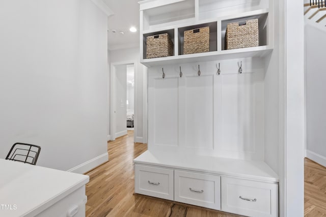 911 Canterbury Rd, Raleigh, NC 27607 - mudroom featuring baseboards, crown molding, light wood finished floors, and recessed lighting