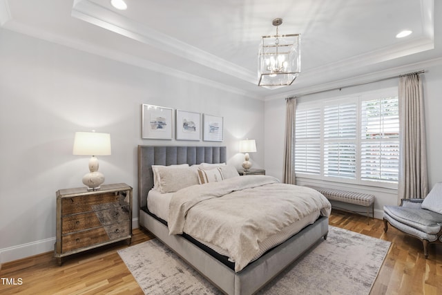 911 Canterbury Rd, Raleigh, NC 27607 - bedroom with a raised ceiling, ornamental molding, a chandelier, light wood finished floors, and recessed lighting