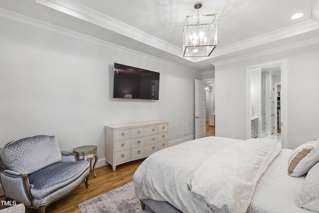 911 Canterbury Rd, Raleigh, NC 27607 - bedroom featuring light wood-type flooring, a chandelier, a tray ceiling, ornamental molding, and baseboards