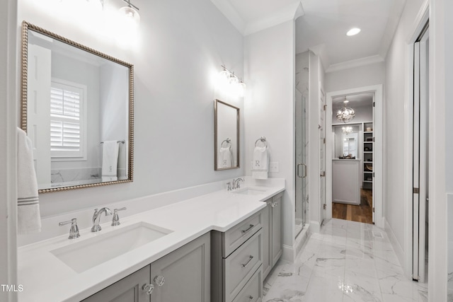 911 Canterbury Rd, Raleigh, NC 27607 - bathroom with crown molding, a shower stall, double vanity, marble finish floors, and baseboards