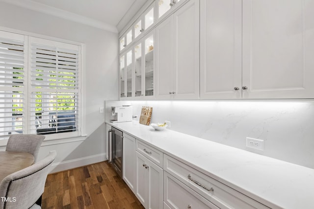911 Canterbury Rd, Raleigh, NC 27607 - kitchen featuring dark wood-type flooring, white cabinets, light countertops, and ornamental molding