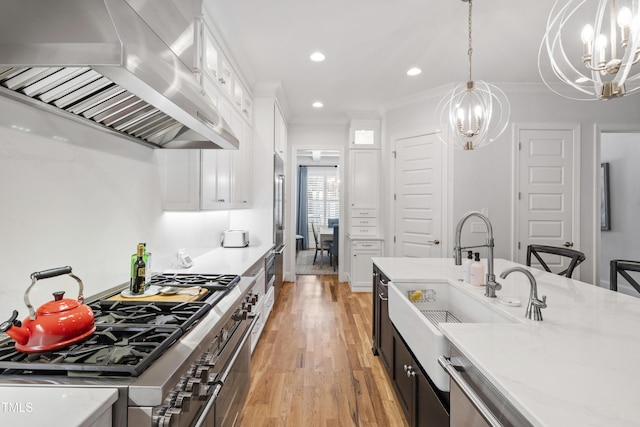 911 Canterbury Rd, Raleigh, NC 27607 - kitchen with extractor fan, a chandelier, stainless steel appliances, a sink, and white cabinetry