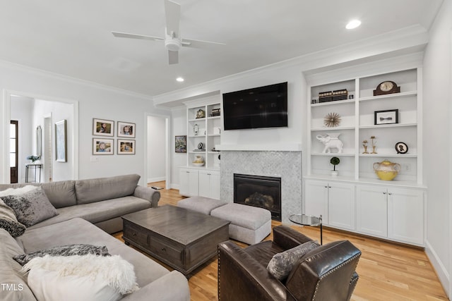 911 Canterbury Rd, Raleigh, NC 27607 - living room featuring ornamental molding, ceiling fan, light wood-style floors, a tile fireplace, and recessed lighting