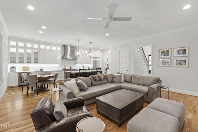 911 Canterbury Rd, Raleigh, NC 27607 - living room with crown molding, stairway, recessed lighting, ceiling fan, and light wood-style flooring