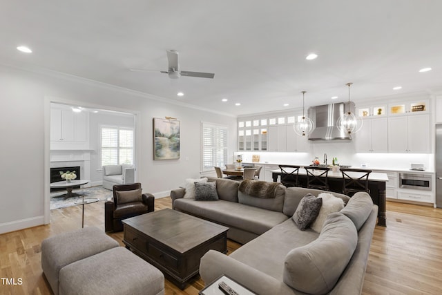 911 Canterbury Rd, Raleigh, NC 27607 - living area featuring crown molding, baseboards, recessed lighting, a ceiling fan, and a high end fireplace