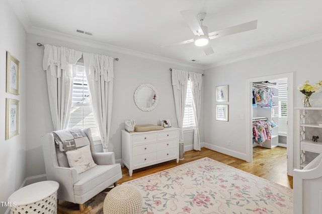 911 Canterbury Rd, Raleigh, NC 27607 - sitting room with ornamental molding, a ceiling fan, wood finished floors, and baseboards