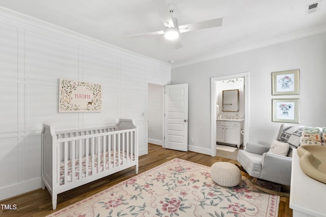911 Canterbury Rd, Raleigh, NC 27607 - bedroom featuring wood finished floors, a crib, crown molding, a ceiling fan, and baseboards