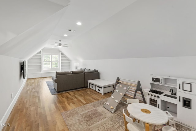 911 Canterbury Rd, Raleigh, NC 27607 - rec room featuring vaulted ceiling, light wood-style floors, built in features, baseboards, and ceiling fan