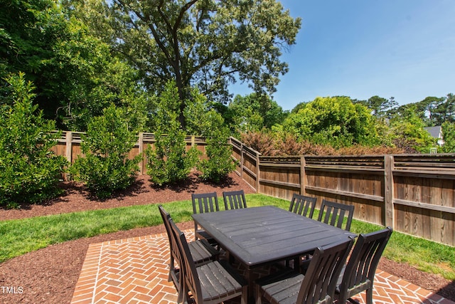 911 Canterbury Rd, Raleigh, NC 27607 - fenced backyard with outdoor dining area and a patio area