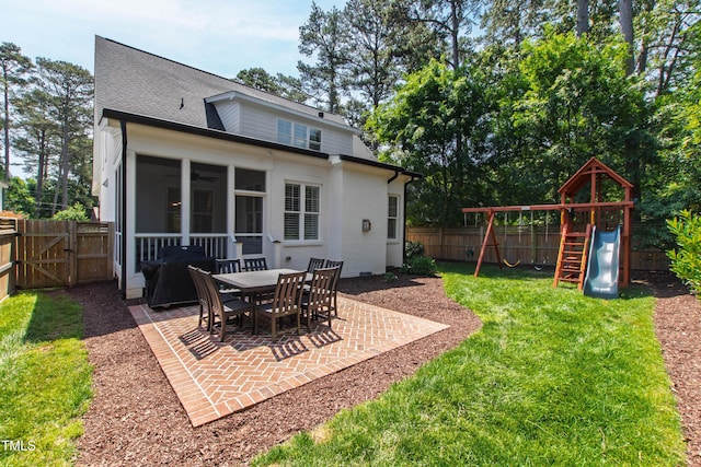 911 Canterbury Rd, Raleigh, NC 27607 - rear view of property with a patio area, a sunroom, a gate, a playground, and roof with shingles