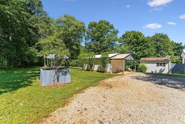 8089 Crawford Currin Rd, Oxford, NC 27565 - view of green lawn with gravel driveway