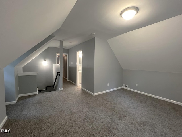 108 W Marsha Gayle Ct, Fuquay Varina, NC 27526 - additional living space with vaulted ceiling, baseboards, and dark colored carpet
