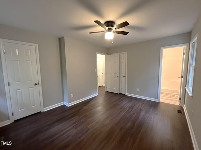 108 W Marsha Gayle Ct, Fuquay Varina, NC 27526 - unfurnished bedroom featuring dark wood-style flooring, baseboards, connected bathroom, and ceiling fan