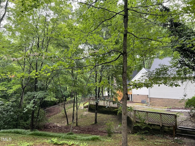 108 W Marsha Gayle Ct, Fuquay Varina, NC 27526 - view of yard featuring a deck and a wooded view