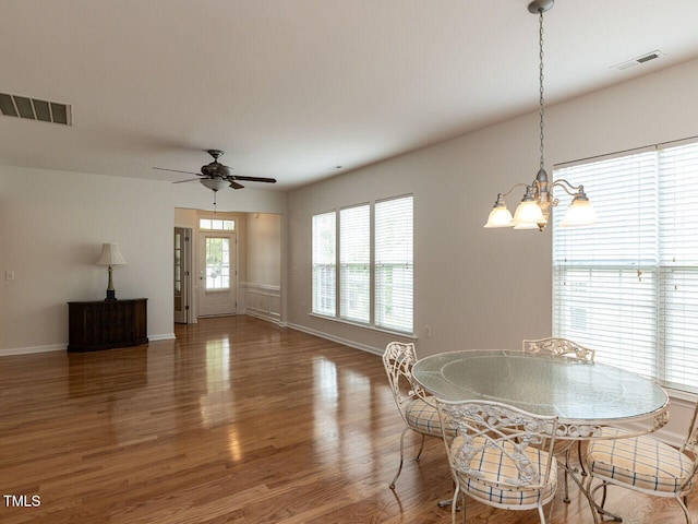 207 Callum Pl, Cary, NC 27519 - dining room featuring wood finished floors, baseboards, a ceiling fan, and a chandelier