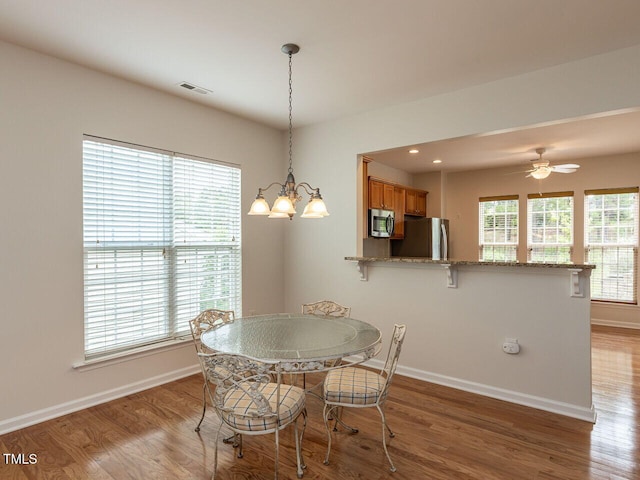 207 Callum Pl, Cary, NC 27519 - dining area with baseboards, wood finished floors, a chandelier, and recessed lighting