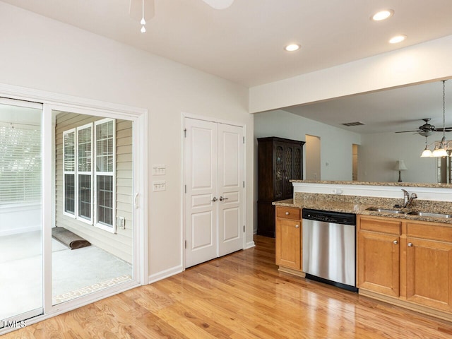 207 Callum Pl, Cary, NC 27519 - kitchen with stainless steel dishwasher, a sink, a ceiling fan, light wood-type flooring, and stone counters