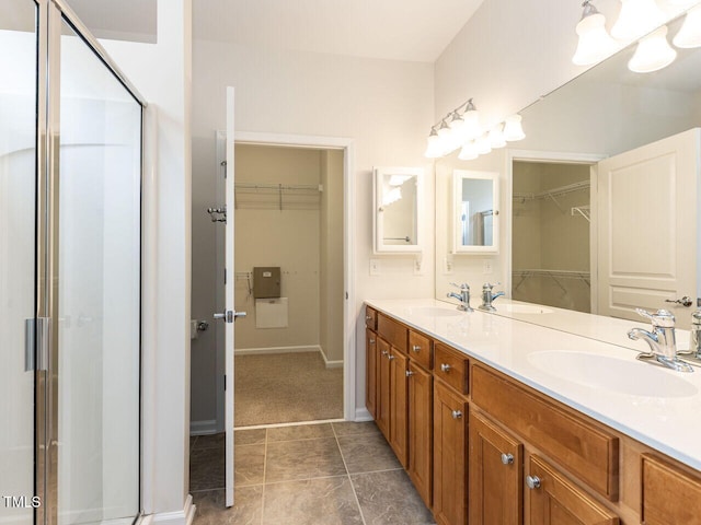 207 Callum Pl, Cary, NC 27519 - bathroom featuring a spacious closet, a shower stall, double vanity, tile patterned floors, and baseboards