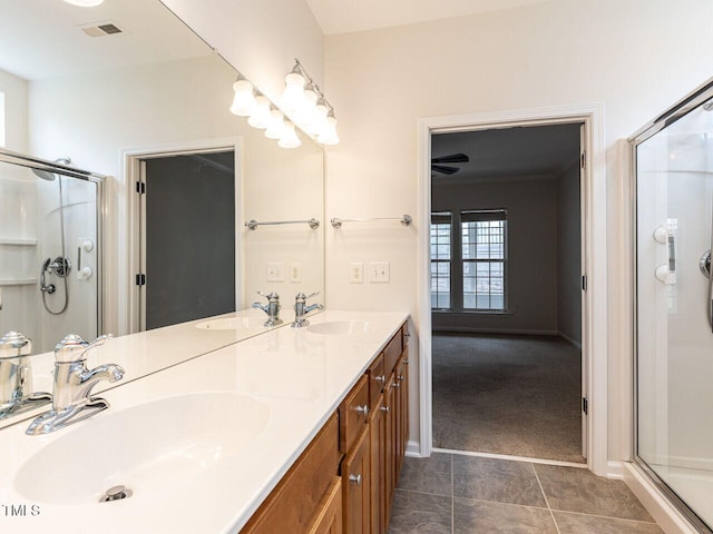 207 Callum Pl, Cary, NC 27519 - full bath with a stall shower, double vanity, tile patterned flooring, and baseboards