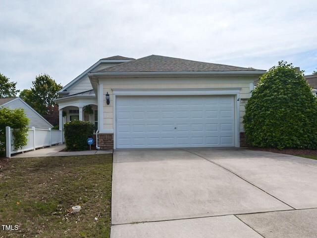 207 Callum Pl, Cary, NC 27519 - view of front of house featuring concrete driveway, stone siding, and a garage