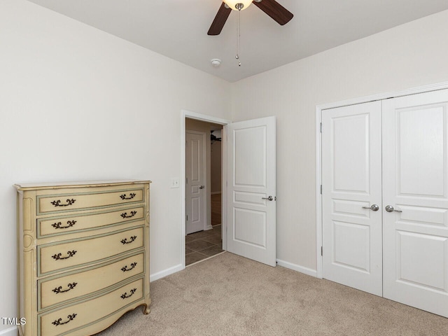 207 Callum Pl, Cary, NC 27519 - bedroom with light colored carpet, baseboards, a closet, and ceiling fan