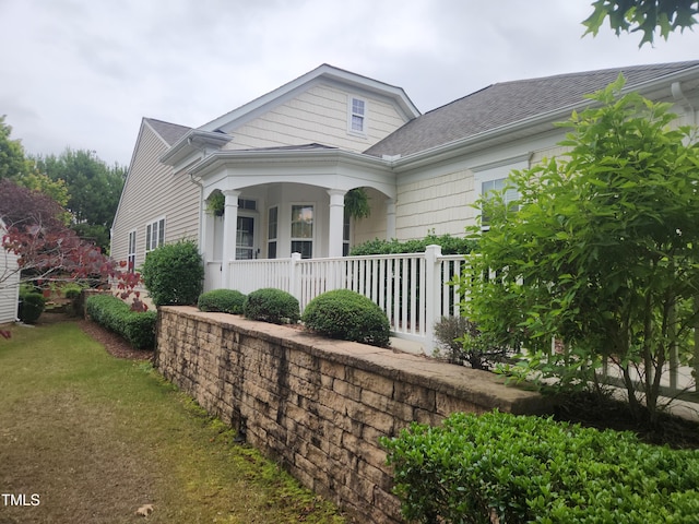 207 Callum Pl, Cary, NC 27519 - view of front facade with a porch, roof with shingles, and a front yard