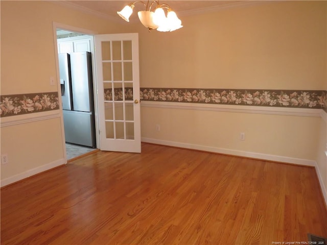 103 Autumn Chase Blvd, Lumberton, NC 28358 - unfurnished dining area featuring a chandelier, crown molding, baseboards, wood finished floors, and wainscoting