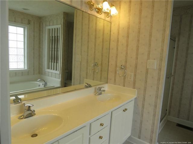 103 Autumn Chase Blvd, Lumberton, NC 28358 - full bath featuring a garden tub, wallpapered walls, double vanity, toilet, and a chandelier