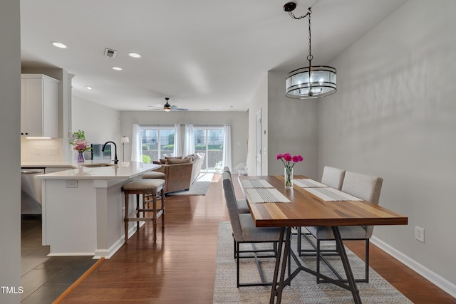 8404 Saltwood Pl, Raleigh, NC 27617 - dining area with ceiling fan, dark wood-style flooring, recessed lighting, baseboards, and a chandelier