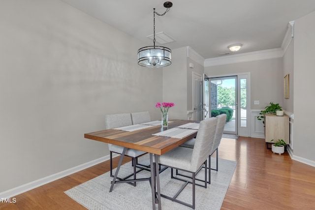 8404 Saltwood Pl, Raleigh, NC 27617 - dining area featuring a chandelier, light wood-style flooring, and crown molding